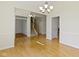 Spacious living room with hardwood floors, chair railing, and a view into other areas of the house at 10911 Innisbrooke Ln, Fishers, IN 46037