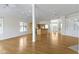 Spacious living room with hardwood floors, natural light, and kitchen view at 10911 Innisbrooke Ln, Fishers, IN 46037