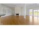 Open concept living room with fireplace, built-ins, and access to the outside at 10911 Innisbrooke Ln, Fishers, IN 46037