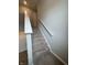 Carpeted staircase with white trim and handrail leading to the upper level at 10931 N Longbranch St, Monrovia, IN 46157