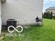 Landscaped backyard with an outdoor grill and healthy green grass near the home at 11555 Ross Common Dr, Indianapolis, IN 46229