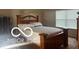 This bedroom boasts a full bed, a window and a closet at 11555 Ross Common Dr, Indianapolis, IN 46229
