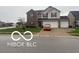 Charming two-story home with a three-car garage and well-maintained lawn at 11555 Ross Common Dr, Indianapolis, IN 46229