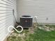 Exterior view of a modern HVAC unit with gray decorative metal surrounding a gray house at 11555 Ross Common Dr, Indianapolis, IN 46229