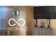 This living room features a decorative mirror, a mounted TV and a side console at 11555 Ross Common Dr, Indianapolis, IN 46229