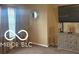 This living room features a decorative mirror, a mounted TV and a side console at 11555 Ross Common Dr, Indianapolis, IN 46229
