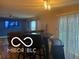 Open concept living space with bar seating and a tv at 11555 Ross Common Dr, Indianapolis, IN 46229