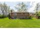 Exterior view of the home with a well-maintained lawn, patio, and mature trees at 1186 Castle Dr, Franklin, IN 46131