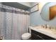 Stylish bathroom features a decorative shower curtain, a round mirror, and a modern vanity at 1186 Castle Dr, Franklin, IN 46131