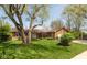 Charming single-story home with a well-manicured lawn and mature tree at 1186 Castle Dr, Franklin, IN 46131