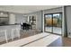 Open dining area featuring wood flooring, a dining table, a breakfast bar and a sliding glass door to the patio at 12005 Hardwick Dr, Fishers, IN 46038