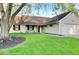 Charming single-story home with well-maintained lawn, complemented by black shutters and a two-car attached garage at 12005 Hardwick Dr, Fishers, IN 46038