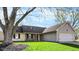 Charming single-story home with well-maintained lawn, complemented by black shutters and a two-car attached garage at 12005 Hardwick Dr, Fishers, IN 46038