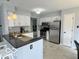 Bright kitchen features white cabinetry and stainless appliances at 12005 Hardwick Dr, Fishers, IN 46038