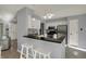 Bright kitchen features white cabinetry, stainless appliances, black countertops and island with bar seating at 12005 Hardwick Dr, Fishers, IN 46038