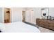 Neutral bedroom with a white bed, natural wood dresser, and closet with storage at 1319 English Ave, Indianapolis, IN 46203