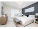 Bedroom with a dark accent wall, a large window, and a comfortable bed at 1319 English Ave, Indianapolis, IN 46203