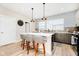 Bright kitchen featuring a large island with seating, pendant lights, and stainless steel appliances at 1319 English Ave, Indianapolis, IN 46203