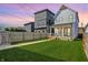 Expansive backyard featuring lush lawn, modern fence, and a view of the charming homes at 1317 Spann Ave, Indianapolis, IN 46203