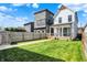 Backyard view showcases a well-manicured lawn, wooden fence, and string lights for a warm ambiance at 1317 Spann Ave, Indianapolis, IN 46203