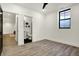 Basement bedroom with a window, luxury vinyl floors, and an adjacent bathroom at 1317 Spann Ave, Indianapolis, IN 46203