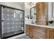 Modern bathroom featuring a shower with decorative tile, wood cabinets, and quartz countertops at 1317 Spann Ave, Indianapolis, IN 46203
