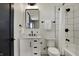 Modern bathroom with white vanity, black fixtures, and tiled shower at 1317 Spann Ave, Indianapolis, IN 46203