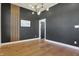 Bright bedroom with hardwood floors, gray accent wall, modern lighting, and decorative wall at 1317 Spann Ave, Indianapolis, IN 46203
