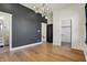 Bright bedroom with hardwood floors, gray accent wall, modern lighting, and walk-in closet at 1317 Spann Ave, Indianapolis, IN 46203