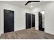 Bedroom boasts hardwood floors and 3 closets leading to bathroom at 1317 Spann Ave, Indianapolis, IN 46203