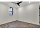 Empty bedroom with hardwood floors, ceiling fan, and natural light at 1317 Spann Ave, Indianapolis, IN 46203