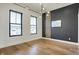 Bright bedroom with hardwood floors, gray accent wall, modern lighting, and natural light at 1317 Spann Ave, Indianapolis, IN 46203
