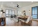 Bright dining room with a modern table, hardwood floors, stylish lighting, and lots of natural light at 1317 Spann Ave, Indianapolis, IN 46203