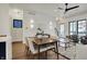Bright dining room with a modern table, hardwood floors, stylish lighting, and opens to the kitchen at 1317 Spann Ave, Indianapolis, IN 46203