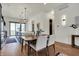 Bright dining room with a modern table, hardwood floors, stylish lighting, and opens to the kitchen at 1317 Spann Ave, Indianapolis, IN 46203