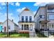 Charming two-story home with a black wrought iron fence, small porch, and well-manicured lawn at 1317 Spann Ave, Indianapolis, IN 46203