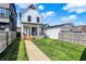 Two-story home with a well-manicured lawn and a covered porch, framed by a wooden fence at 1317 Spann Ave, Indianapolis, IN 46203