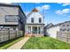 Charming two-story home with a well-manicured lawn, a covered porch and wood steps at 1317 Spann Ave, Indianapolis, IN 46203