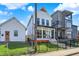 Charming two-story home with a black wrought iron fence, small porch, and well-manicured lawn at 1317 Spann Ave, Indianapolis, IN 46203