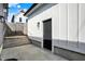 Rear view of the garage featuring a convenient side door and access stairs, surrounded by a fenced yard at 1317 Spann Ave, Indianapolis, IN 46203