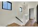 A bright upstairs hallway with hardwood floors and a modern light fixture at 1317 Spann Ave, Indianapolis, IN 46203