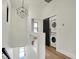A bright upstairs hallway with hardwood floors and a laundry area with stacked washer/dryer at 1317 Spann Ave, Indianapolis, IN 46203