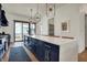 A modern kitchen featuring navy cabinets, a quartz countertop, a large island, stainless steel appliances, and a striped rug at 1317 Spann Ave, Indianapolis, IN 46203