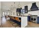 A modern kitchen featuring a waterfall island, stainless appliances, navy cabinets, and stylish pendant lighting at 1317 Spann Ave, Indianapolis, IN 46203