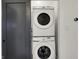 Stacked, full-size, Samsung washer and dryer, with dark colored sliding closet door at 1317 Spann Ave, Indianapolis, IN 46203