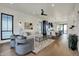 Open-concept living space with hardwood floors, modern furnishings, lots of natural light, and a ceiling fan at 1317 Spann Ave, Indianapolis, IN 46203