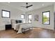 Bright main bedroom with hardwood floors, white walls, fan, and lots of natural light at 1317 Spann Ave, Indianapolis, IN 46203