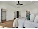 Bright main bedroom with hardwood floors, white walls, closets, and ensuite bathroom at 1317 Spann Ave, Indianapolis, IN 46203