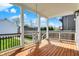 Inviting outdoor porch features a swing, wood floors and black railings, perfect for relaxing and enjoying the backyard view at 1317 Spann Ave, Indianapolis, IN 46203
