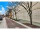 Pleasant street view with trees lining the sidewalk and a brick-patterned walking path at 1317 Spann Ave, Indianapolis, IN 46203